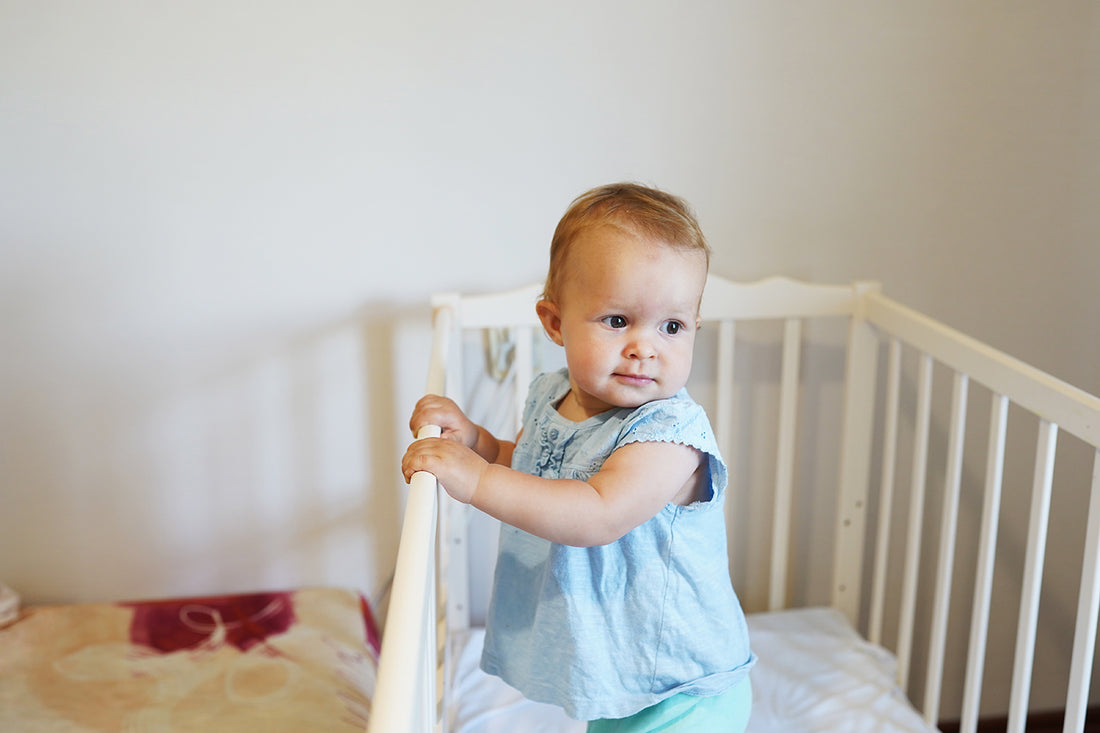 Baby in crib experiencing 9-month sleep regression