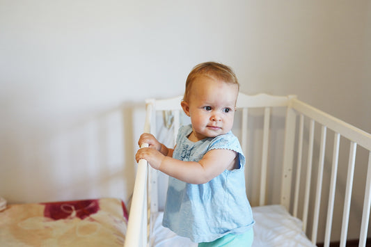 Baby in crib experiencing 9-month sleep regression