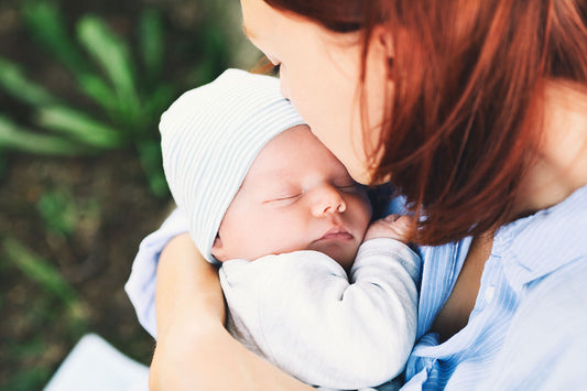 new-mom-kissing-newborn-baby