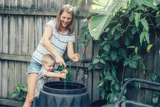 A mother composts with her son