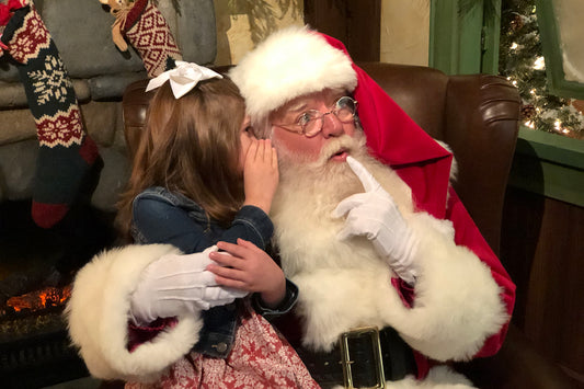little-girl-sitting-on-santas-lap