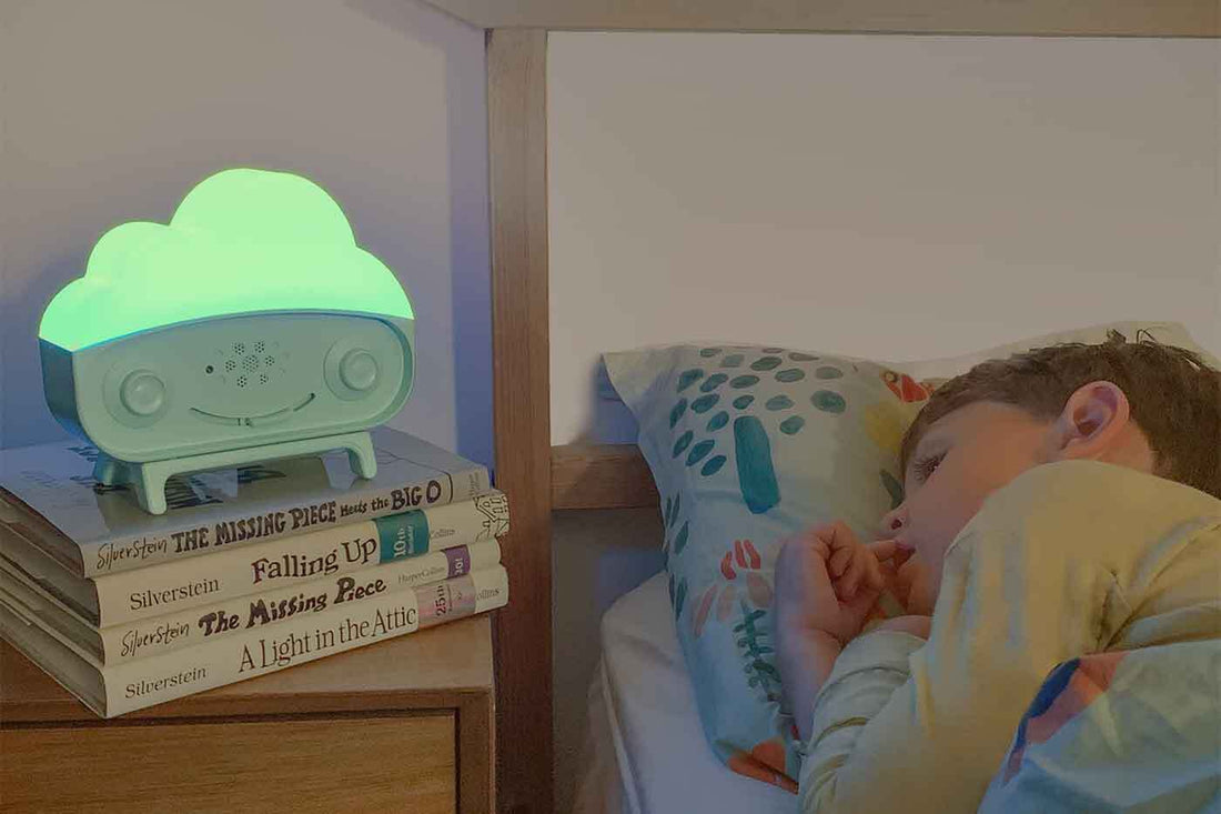 A child sleeps while SNOObie nightlight shines