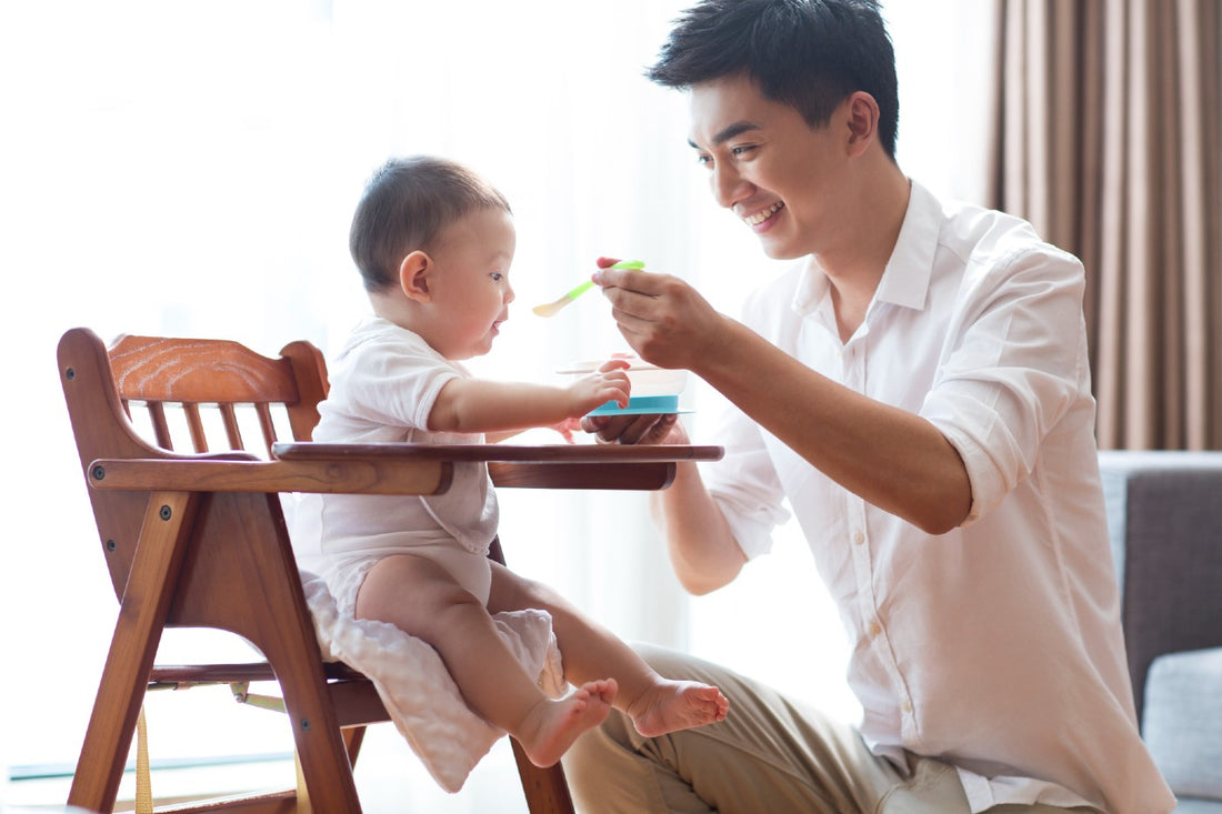 Dad feeding a baby protein