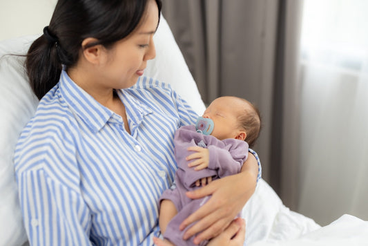 Mother recovering from c-section while holding newborn