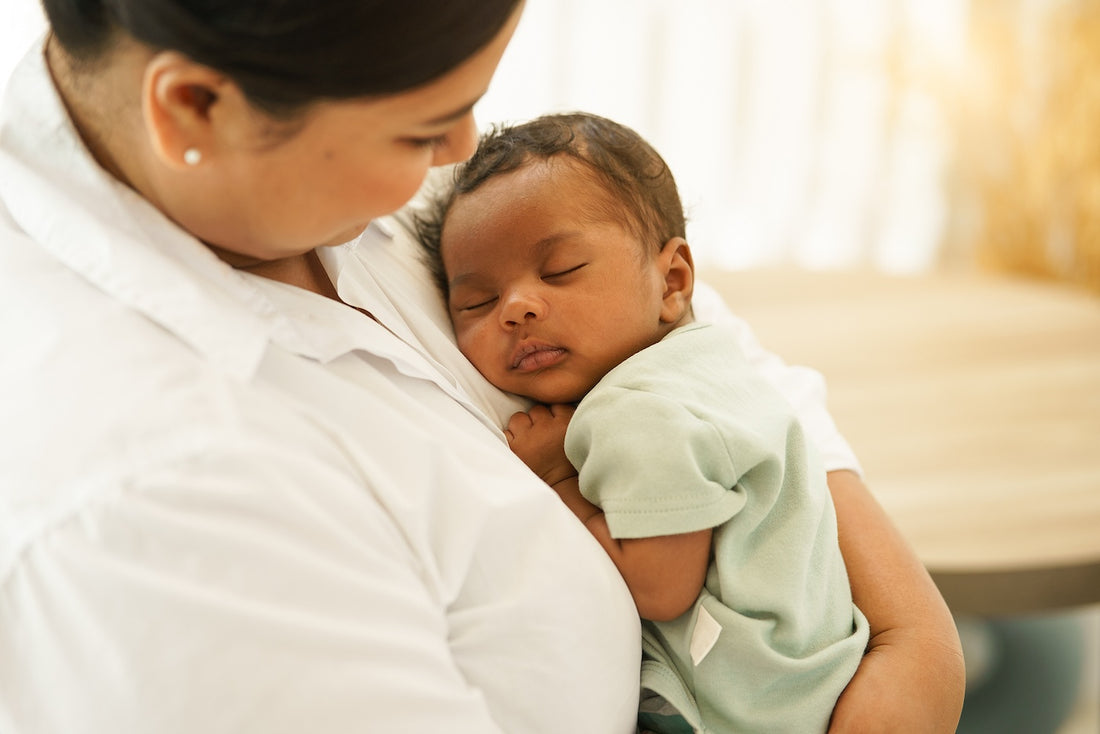 A baby contact naps on Mum