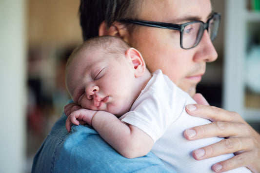 postnatal depression in dads: dad holding a newsborn