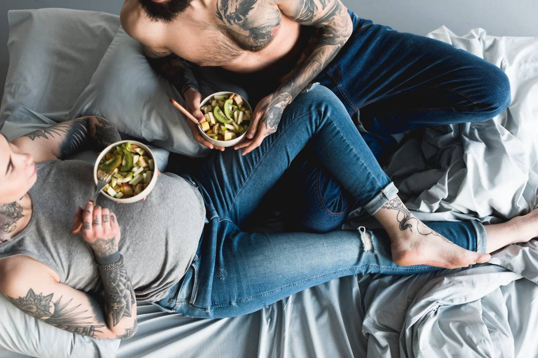 Pregnant mum eats healthy food with her partner