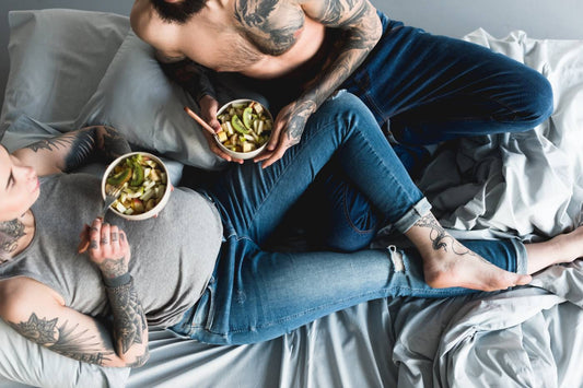Pregnant mum eats healthy food with her partner