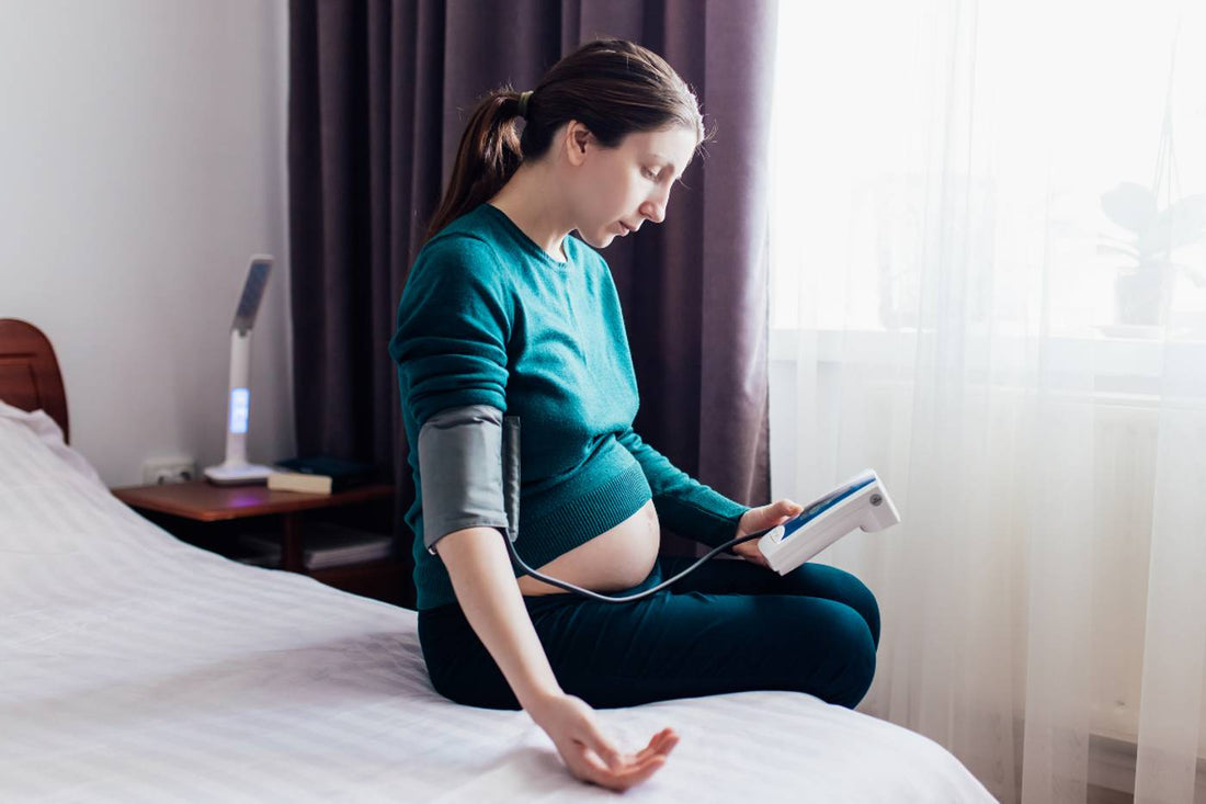 Pregnant woman checking blood pressure