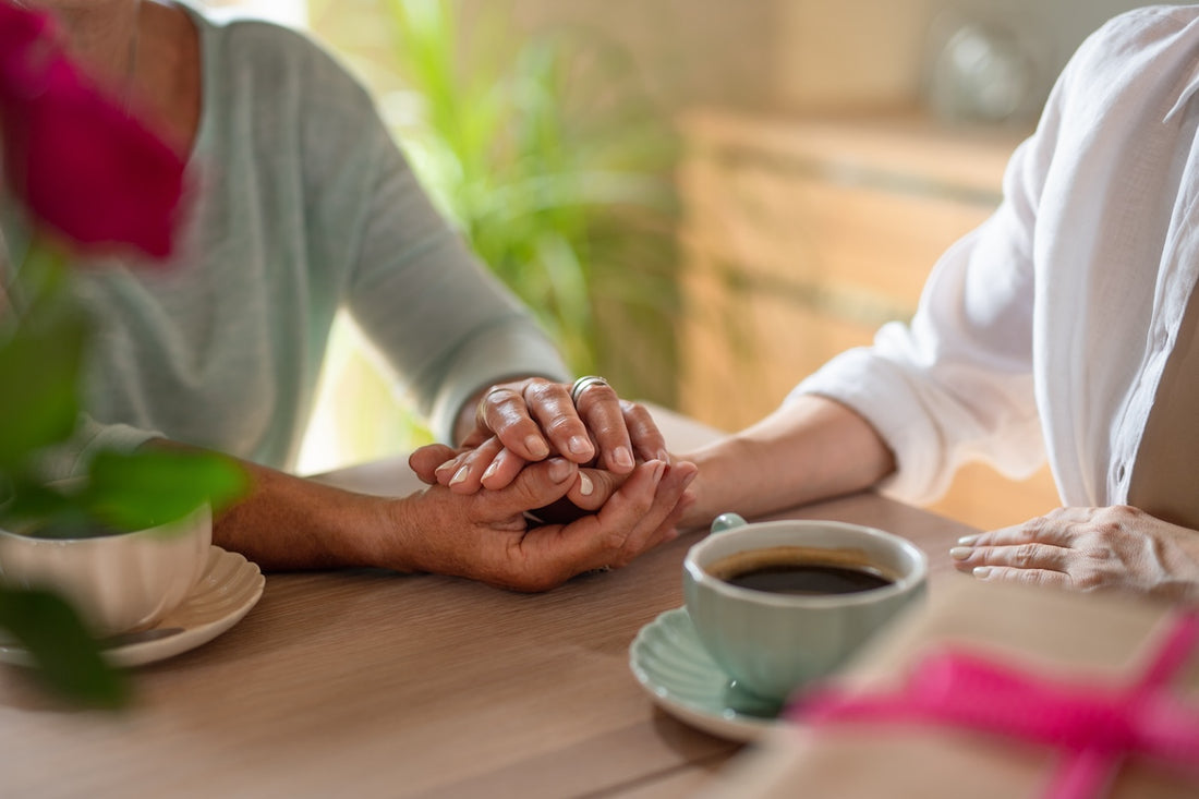 A woman comforts her friend after pregnancy loss