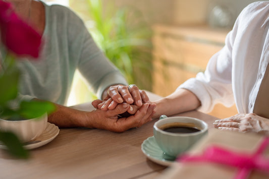 A woman comforts her friend after pregnancy loss