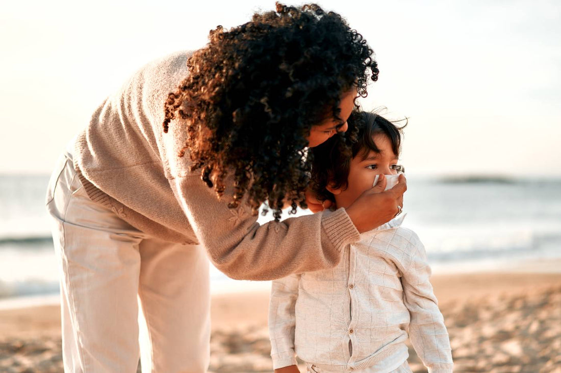 decoding mucus color: mom helping toddler blow nose