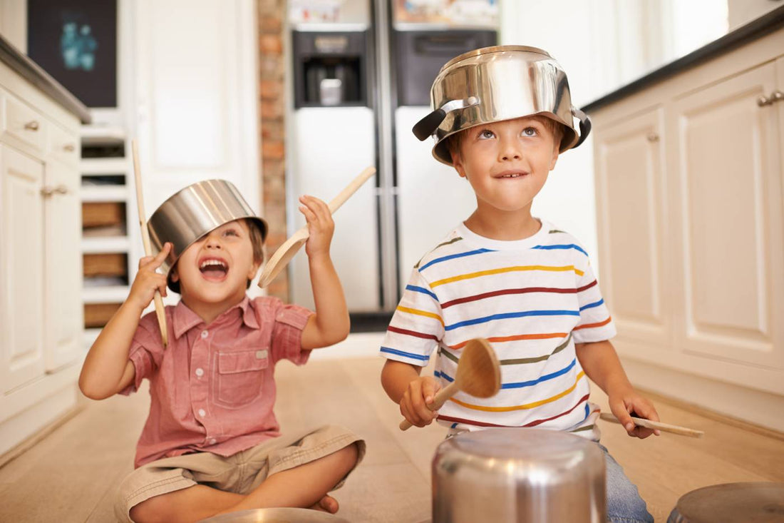 toddlers playing instruments in kitchen