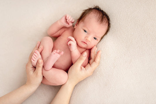 Curled up newborn baby