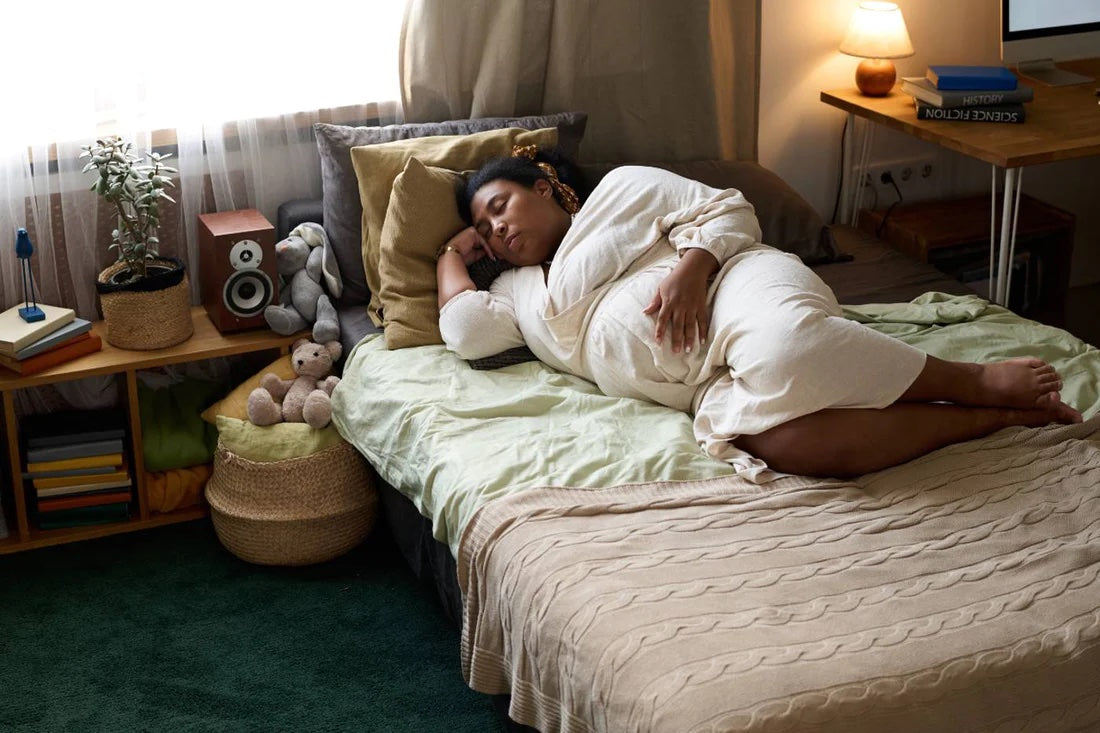 Tired pregnant woman laying on a bed