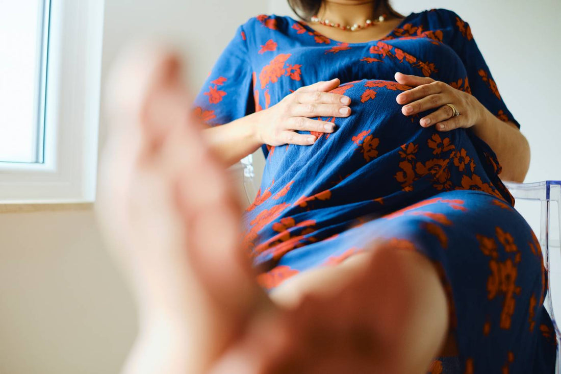 Pregnant woman elevating feet due to pregnancy swelling