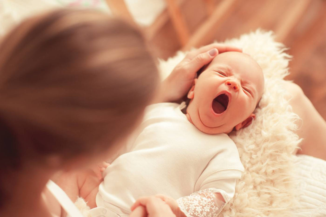 3-month sleep regression: mom holding tired 3-month-old