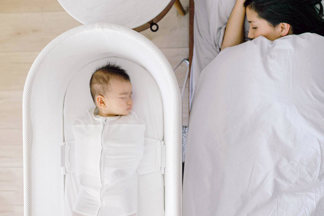 Baby sleeping in SNOO next to sleeping parent