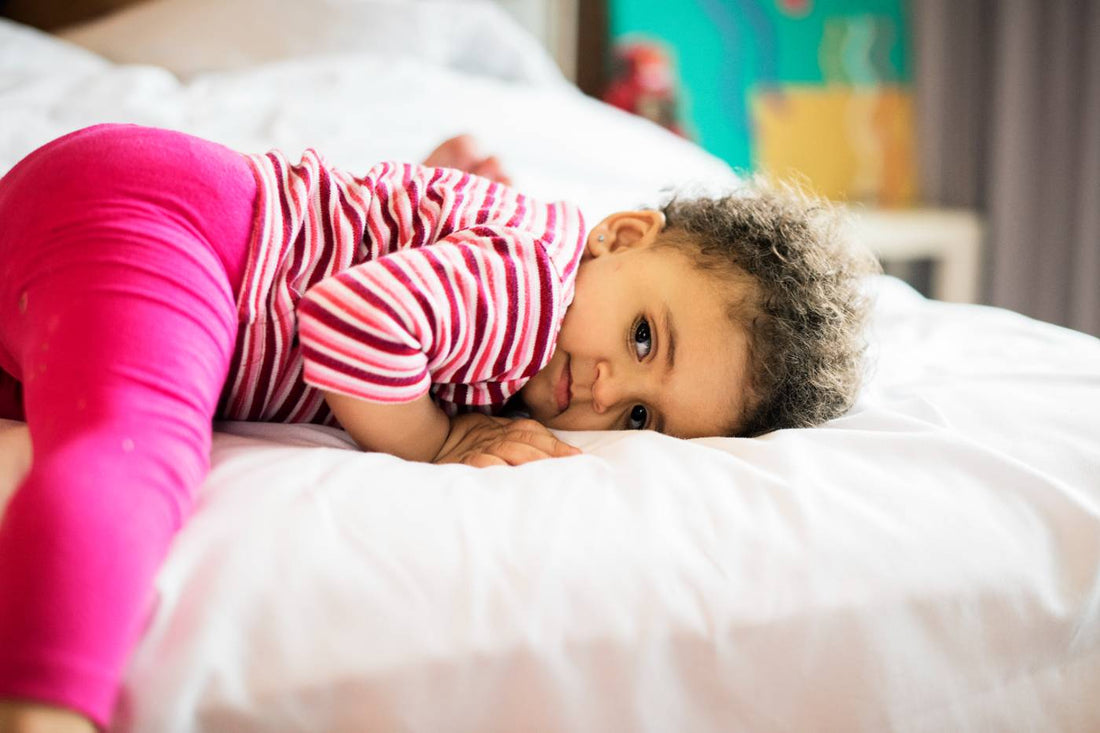 Sleepy toddler on a bed