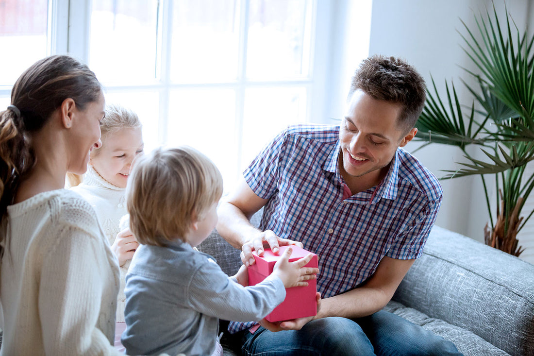 father's day gift ideas: dad opening gift with family