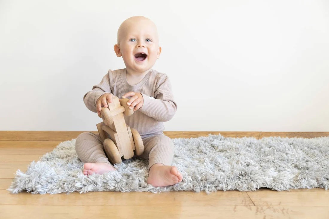 A baby plays with a safe toy