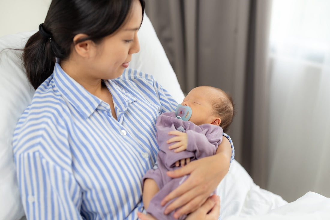 Mother recovering from c-section while holding newborn