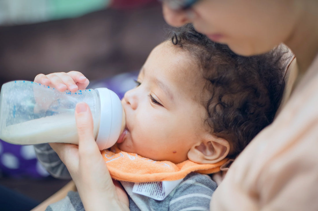 Baby drinks from a bottle